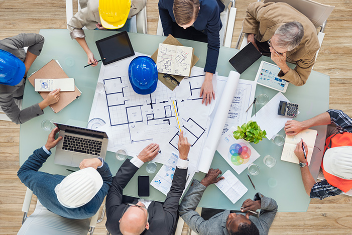 People planning a construction project around a table