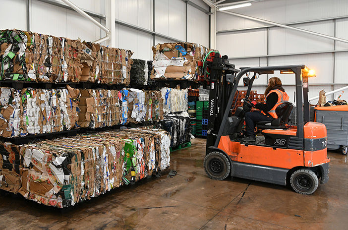 Axil Integrated Services stacking cardboard with a forklift truck