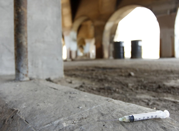 A syringe discarded on the floor