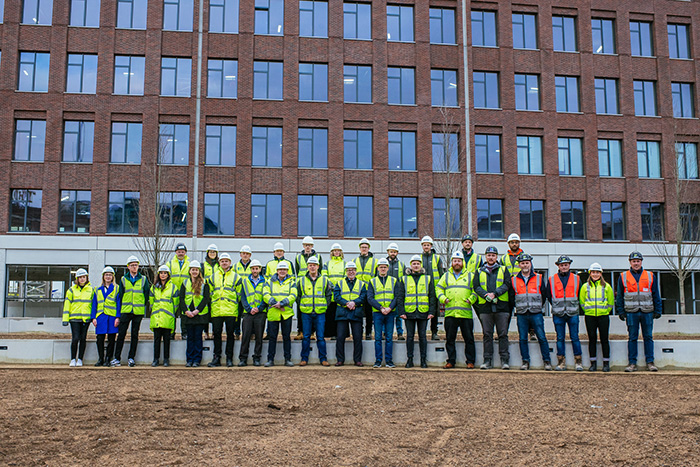 Vastint UK representatives, Leeds City Council members and contractors gather outside the new buildings