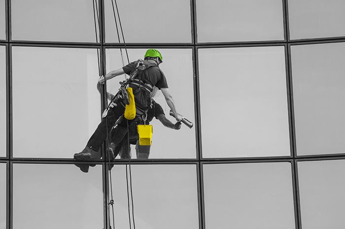 Floorbrite, a window cleaner abseiling down the build to access windows