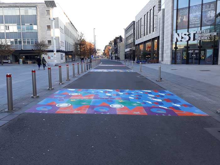 Road with a colourful image printed on the crossing strip.
